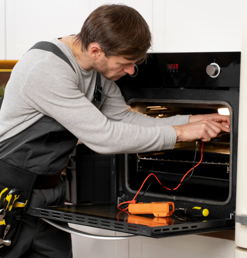 a man repairing the oven